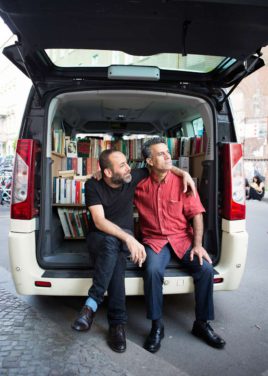Hiwa K and Bakir Aki in front of the taxi-library